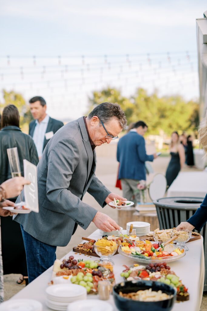 Guest getting charcuterie at Cal Poly's EIM event at The White Barn by San Luis Obispo Wedding Photographer Austyn Elizabeth Photography