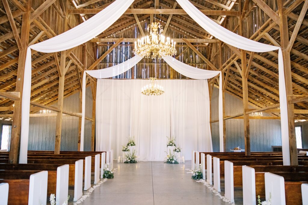 White drapery helps brighten up dark barn chapel for wedding ceremony at Lamoure Vineyard wedding by Pismo Beach wedding photographer Austyn Elizabeth Photography