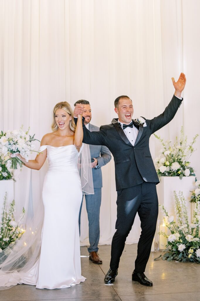 Bride and groom with arms in the air at Lamoure Vineyard wedding by Pismo Beach wedding photographer Austyn Elizabeth Photography