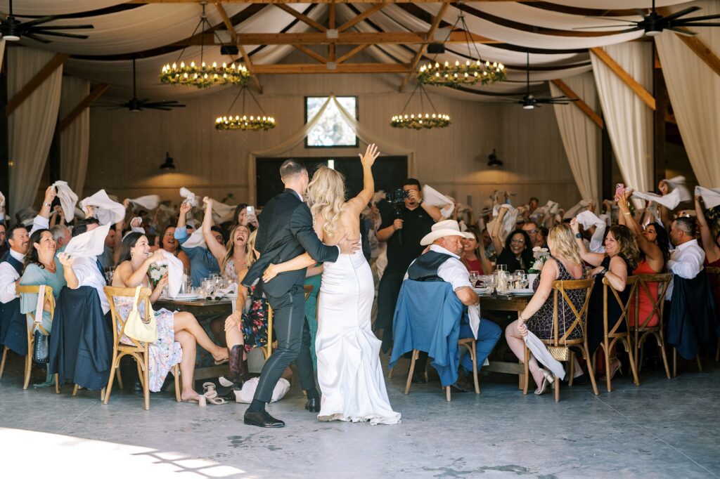 Guests wave napkins at Lamoure Vineyard wedding by Pismo Beach wedding photographer Austyn Elizabeth Photography