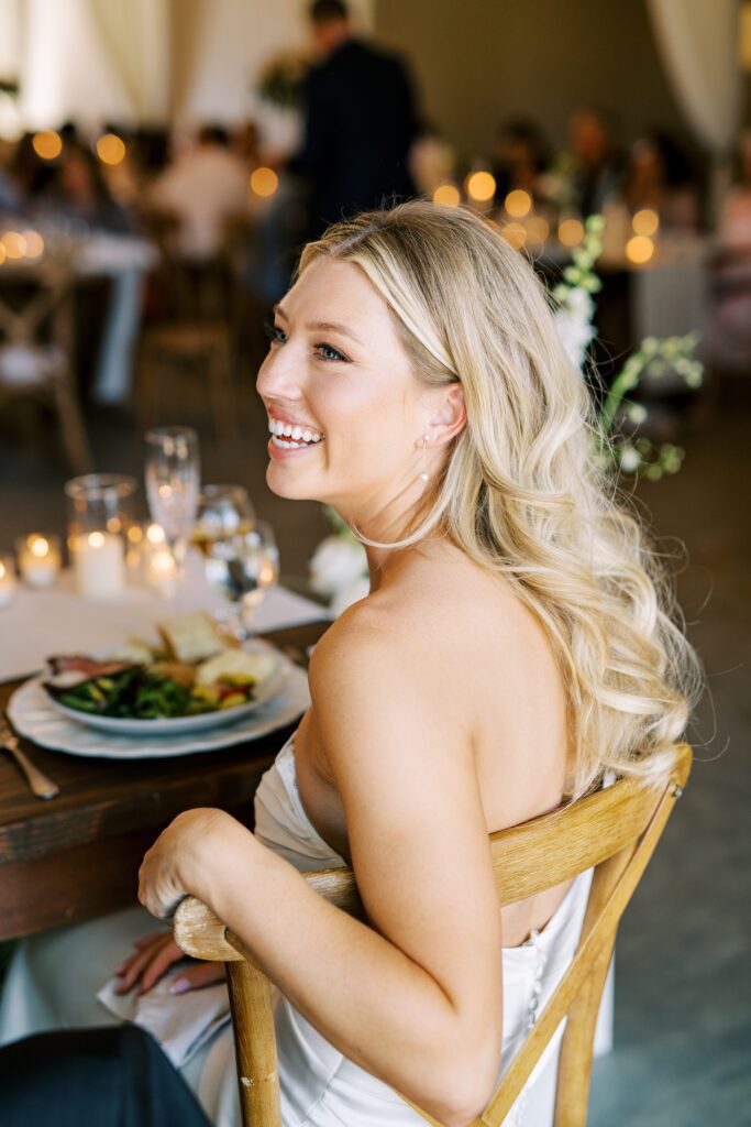 Bride laughing during reception at Lamoure Vineyard wedding by San Luis Obispo wedding photographer Austyn Elizabeth Photography