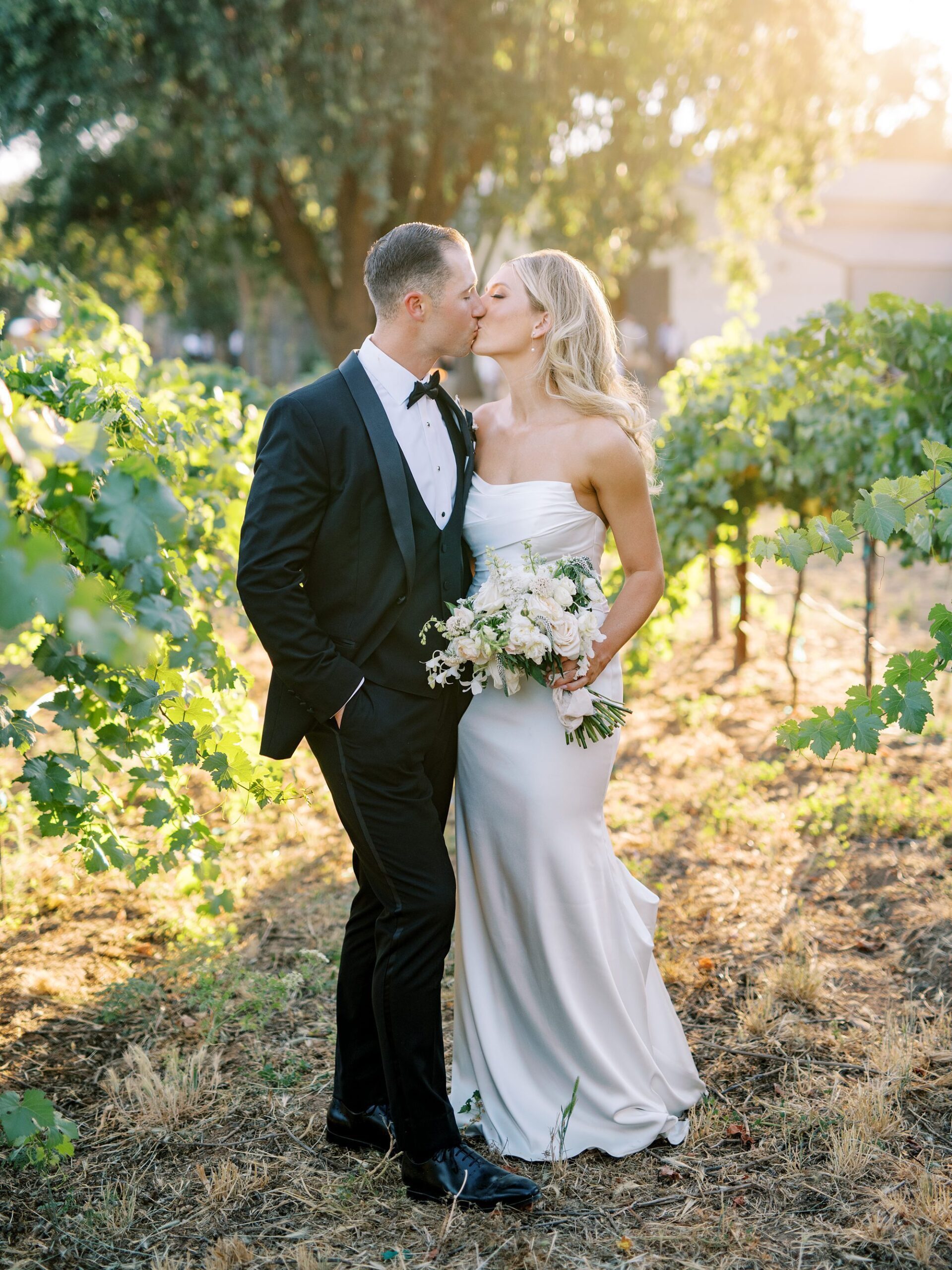 Bride and groom kiss in the vineyards at Lamoure Vineyard wedding by San Luis Obispo wedding photographer Austyn Elizabeth Photography