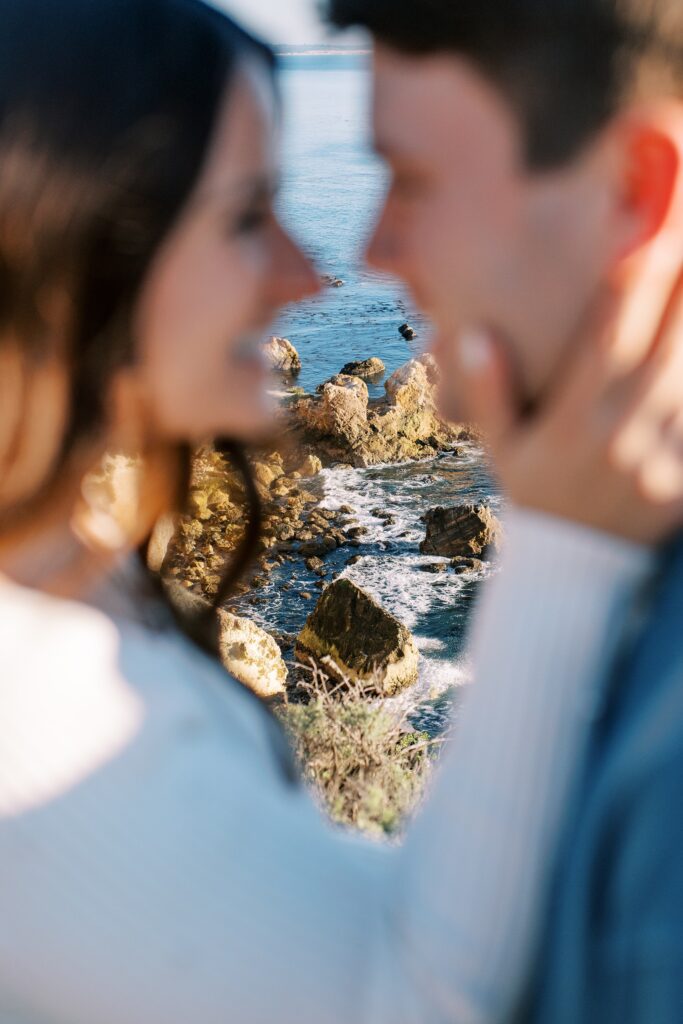 Couple embrace with peak of the ocean in view behind them at Pismo Beach Engagement session by Pismo Beach Wedding Photographer Austyn Elizabeth Photography