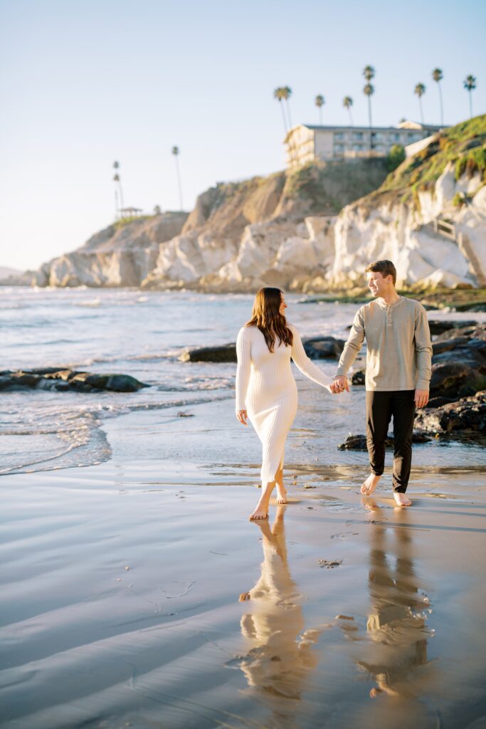 Couple walk hand in hand on sand at Pismo Beach Engagement session by Pismo Beach Wedding Photographer Austyn Elizabeth Photography