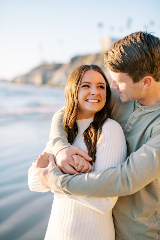 Bride smiles up and groom at Pismo Beach Engagement session by Pismo Beach Wedding Photographer Austyn Elizabeth Photography