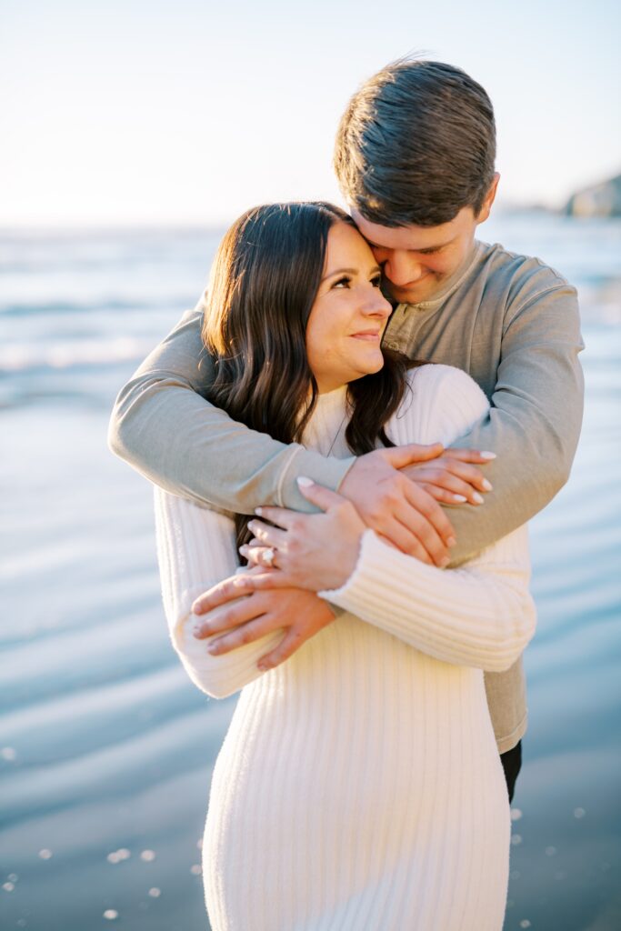 guy wraps arms around bride at Central Coast Engagement session by Pismo Beach Engagement Photographer Austyn Elizabeth Photography
