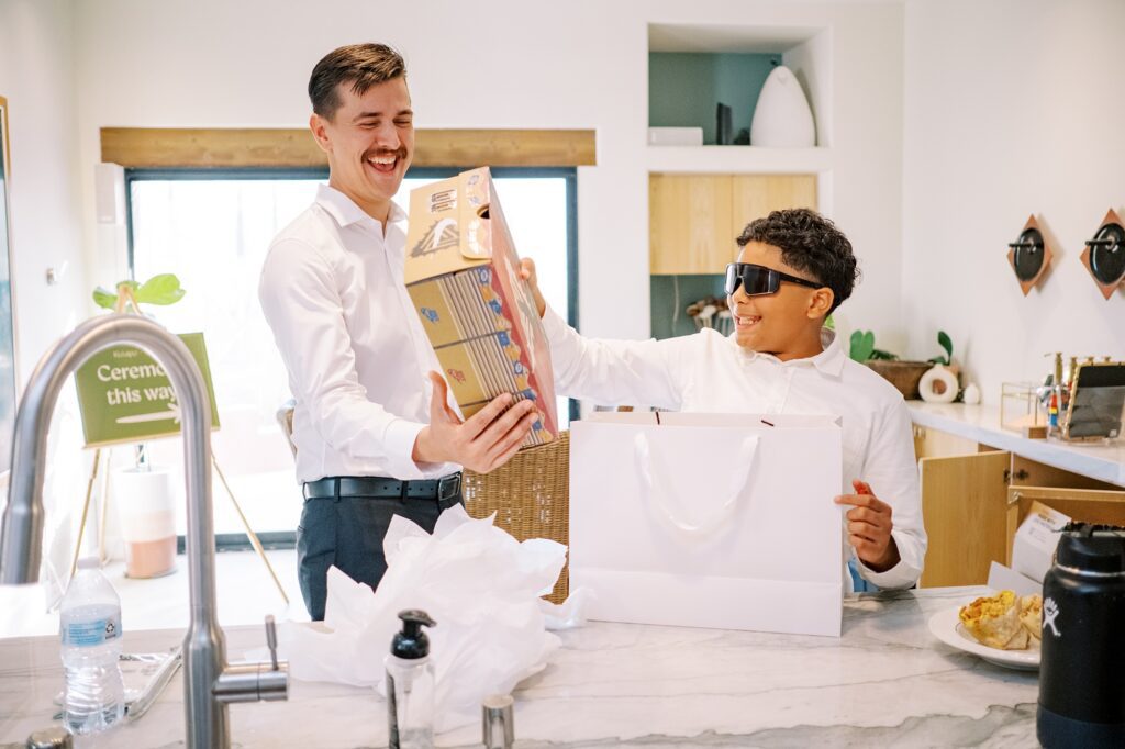 Groom gifting Portland Nikes to groomsmen at Villa Leche wedding by Palm Springs Wedding Photographer Austyn Elizabeth Photography