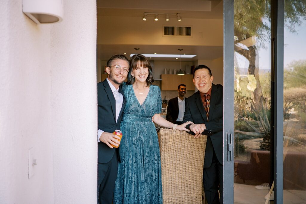 Grooms best man and mom and dad watching first look at Villa Leche wedding by Palm Springs Wedding Photographer Austyn Elizabeth Photography