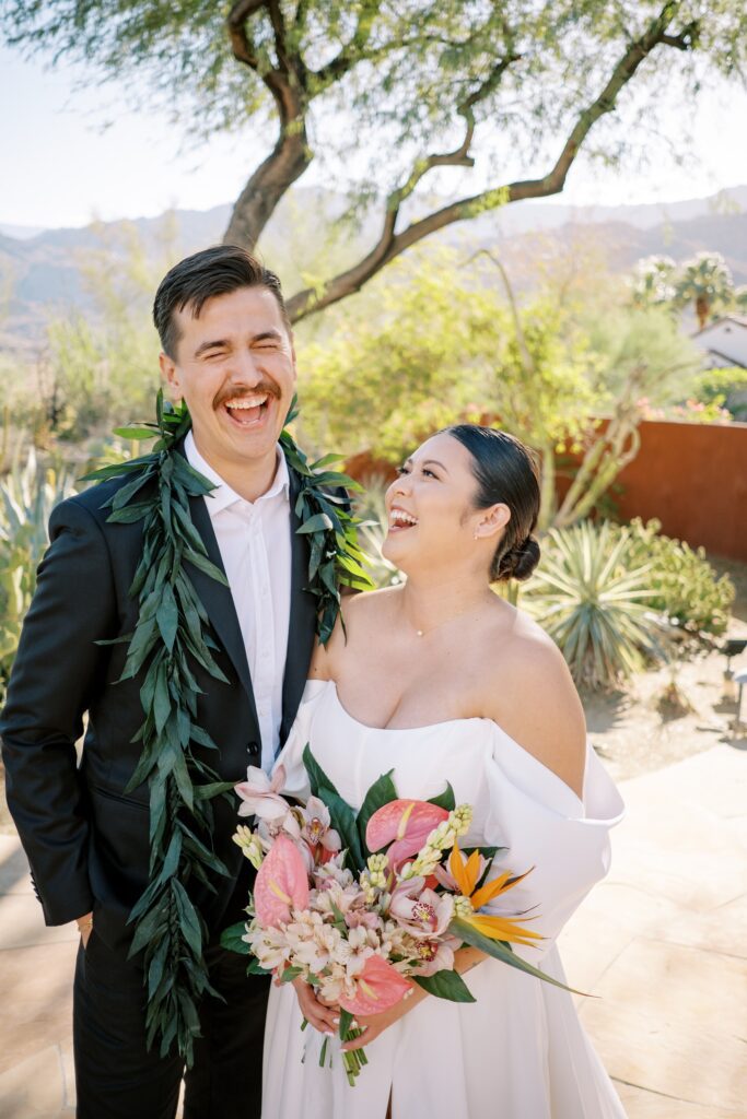 Bride and groom laughing in cactus garden at Villa Leche wedding by Palm Springs Wedding Photographer Austyn Elizabeth Photography
