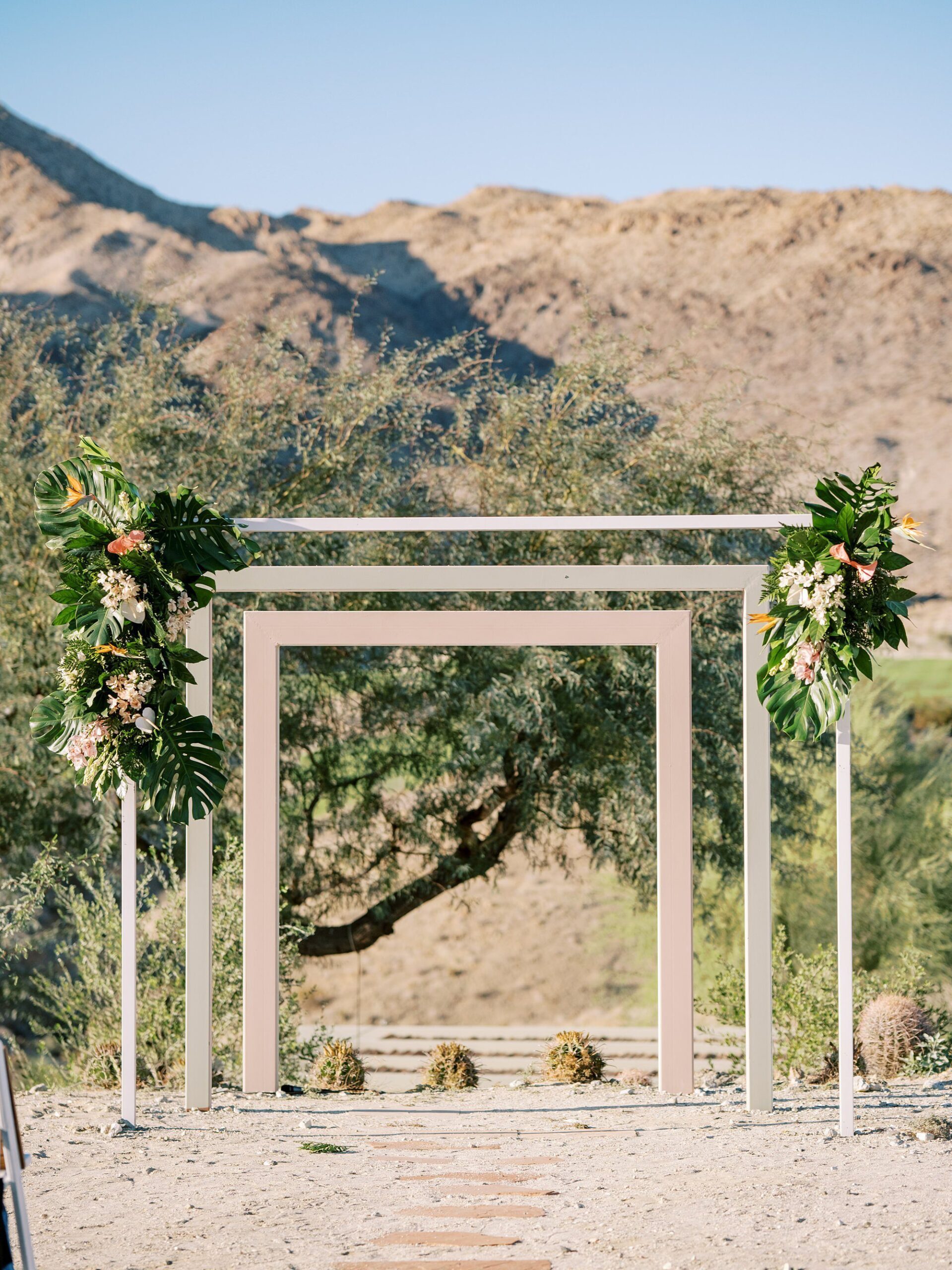 Modern square ceremony arches with Palm Springs hills in background at Villa Leche wedding by Palm Springs Wedding Photographer Austyn Elizabeth Photography