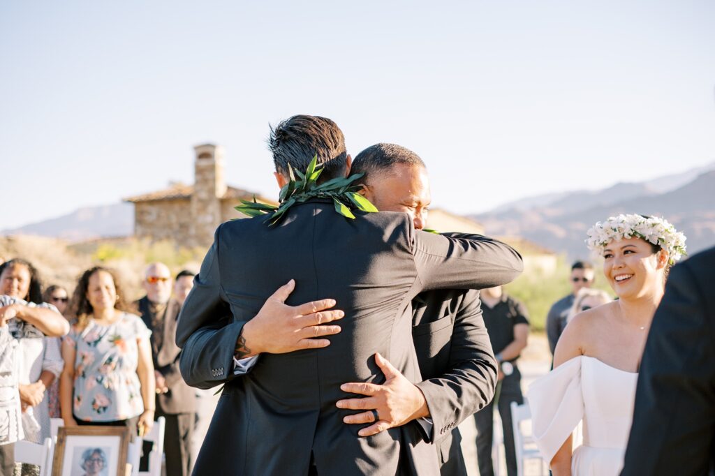 Dad hugs groom at Villa Leche wedding by Palm Springs Wedding Photographer Austyn Elizabeth Photography