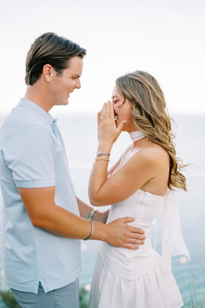 Girlfriend in such surprise after proposal on Catalina Island at Lee's Scenic Overlook on Catalina Island with Avalon Bay in the background, photographed by Avalon Photographer Austyn Elizabeth Photography