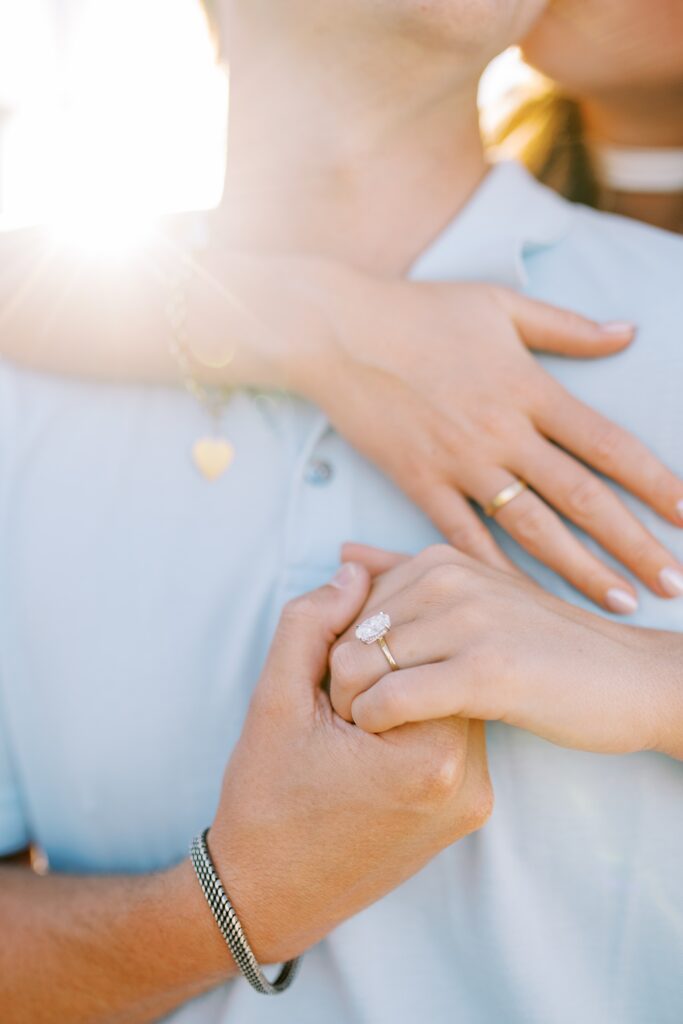 Close up of the engagement ring with sun flair in the background by Catalina Island Surprise Photographer Austyn Elizabeth