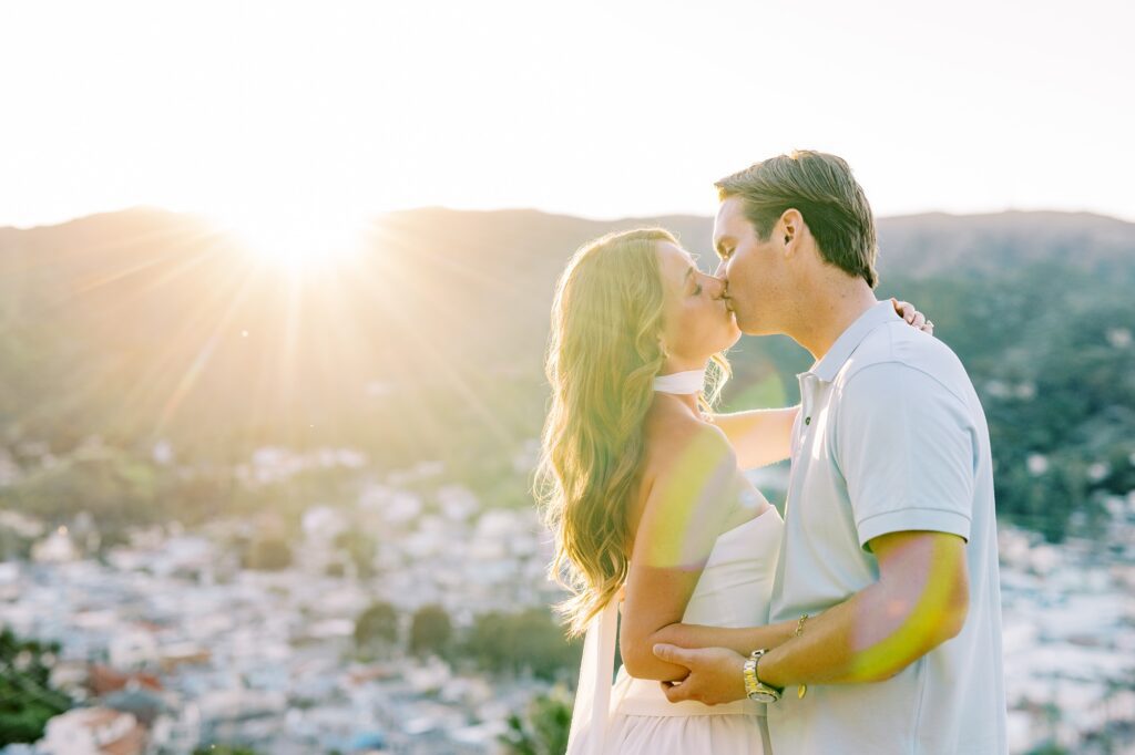 Couple kiss above Avalon during catalina island engagement session by Austyn Elizabeth