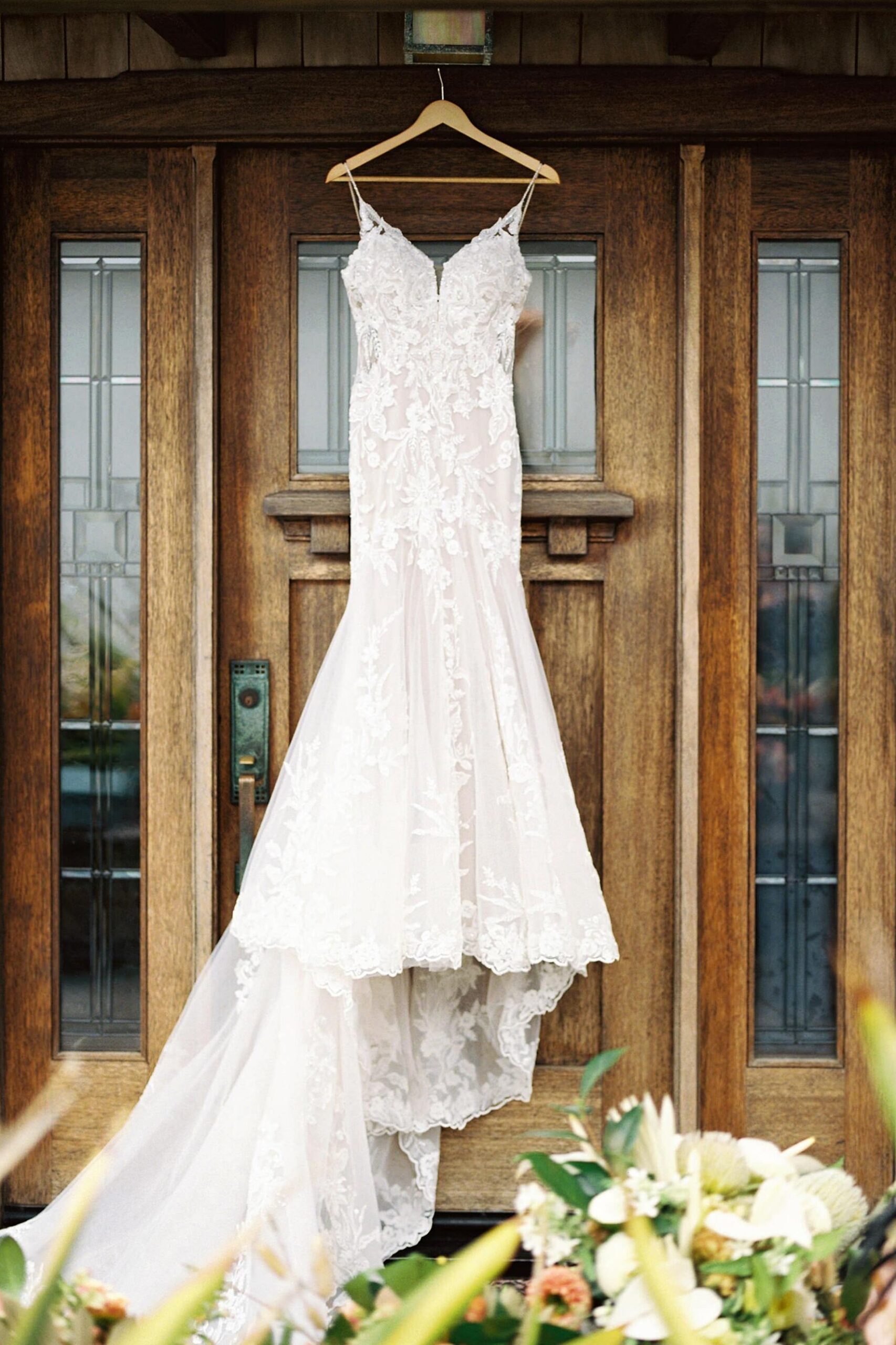Stunning lace wedding dress on wooden door by Cayucos Wedding Photographer on Film by Austyn Elizabeth Photography
