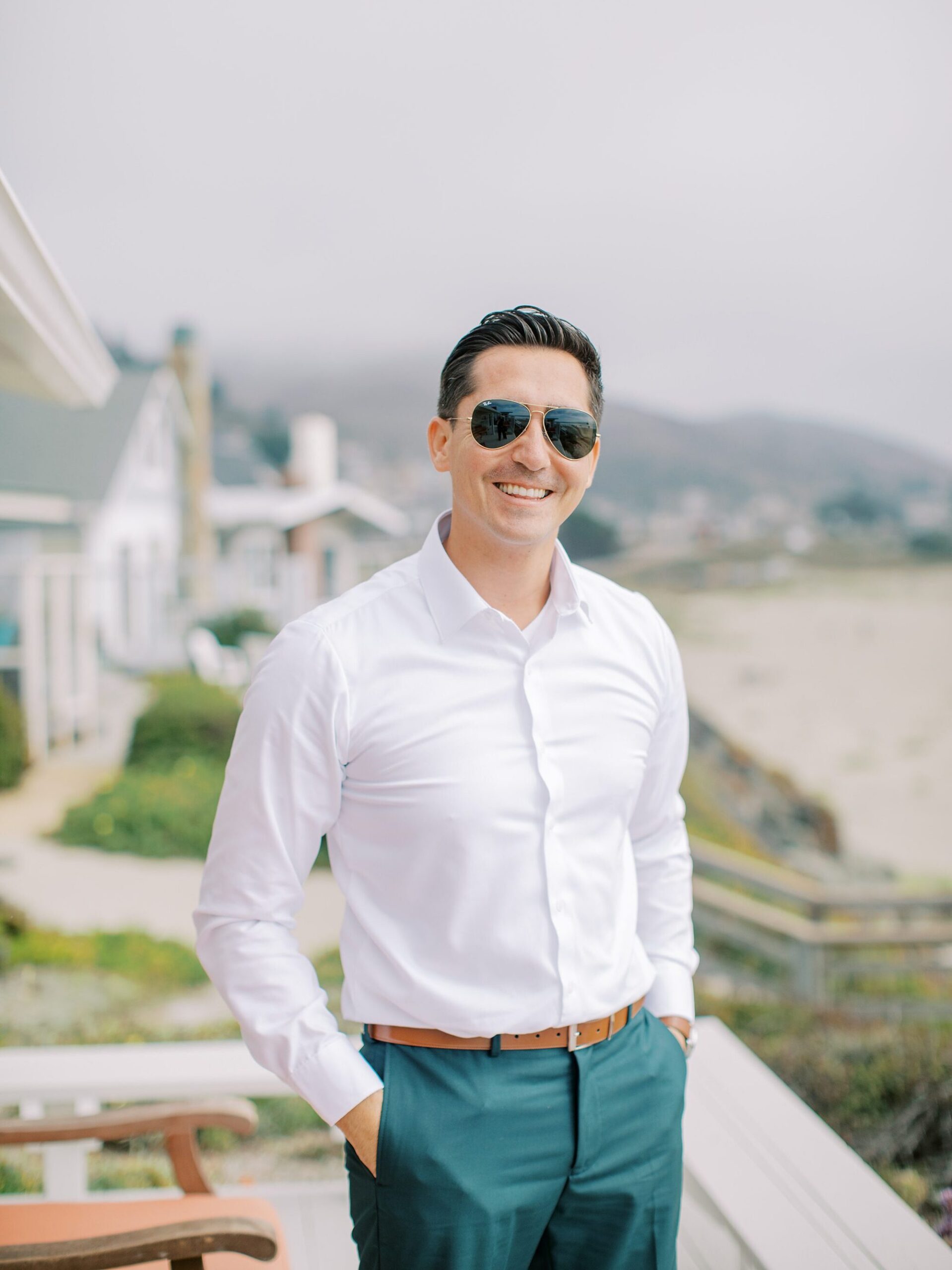 Groom in aviator glasses standing along the beach by Cayucos Wedding Photographer on Film by Austyn Elizabeth Photography
