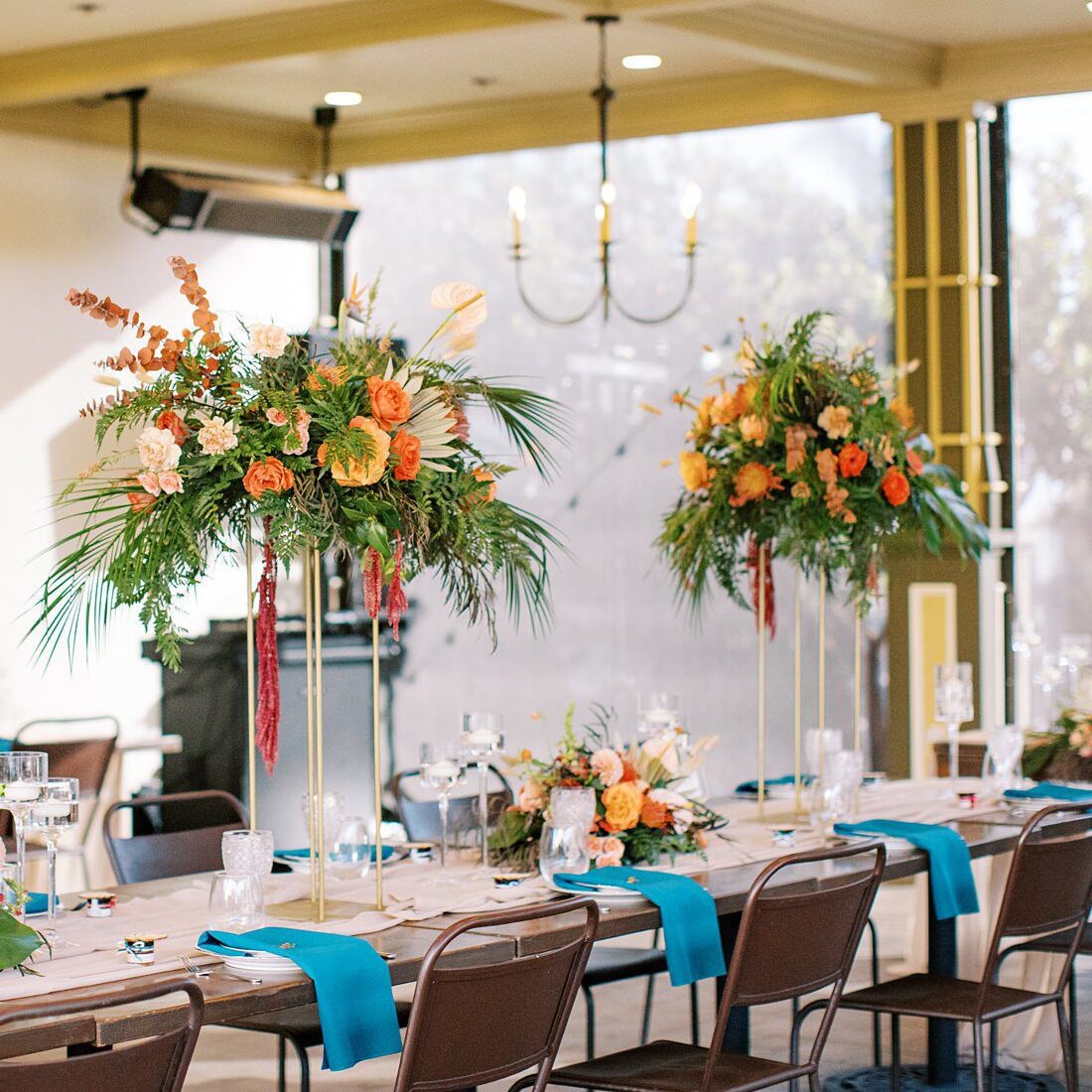 Tropical flowers and gold accents with teal linens by Cayucos Wedding Photographer on Film by Austyn Elizabeth Photography