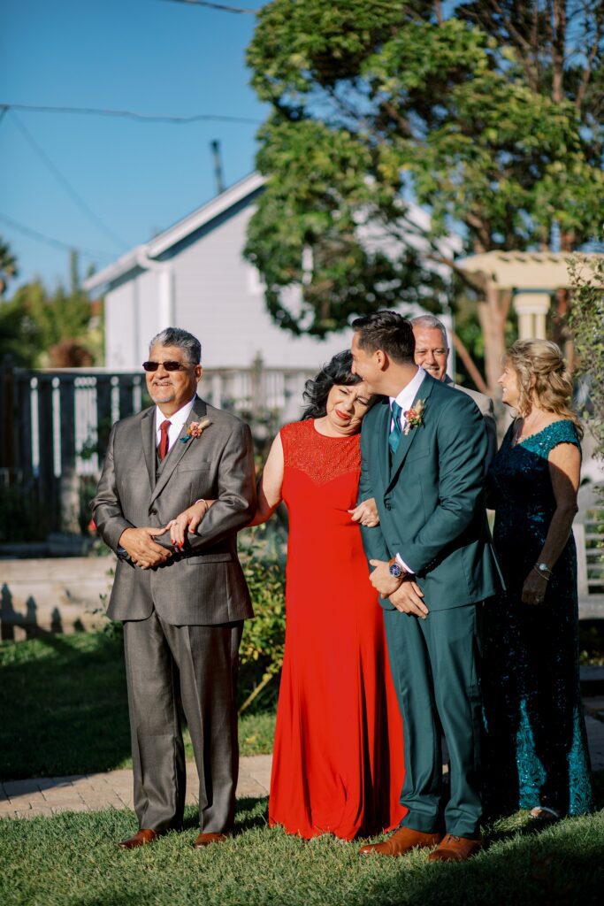 Everyone lined up for wedding and grooms mom hugs groom by Cayucos Wedding Photographer on Film by Austyn Elizabeth Photography