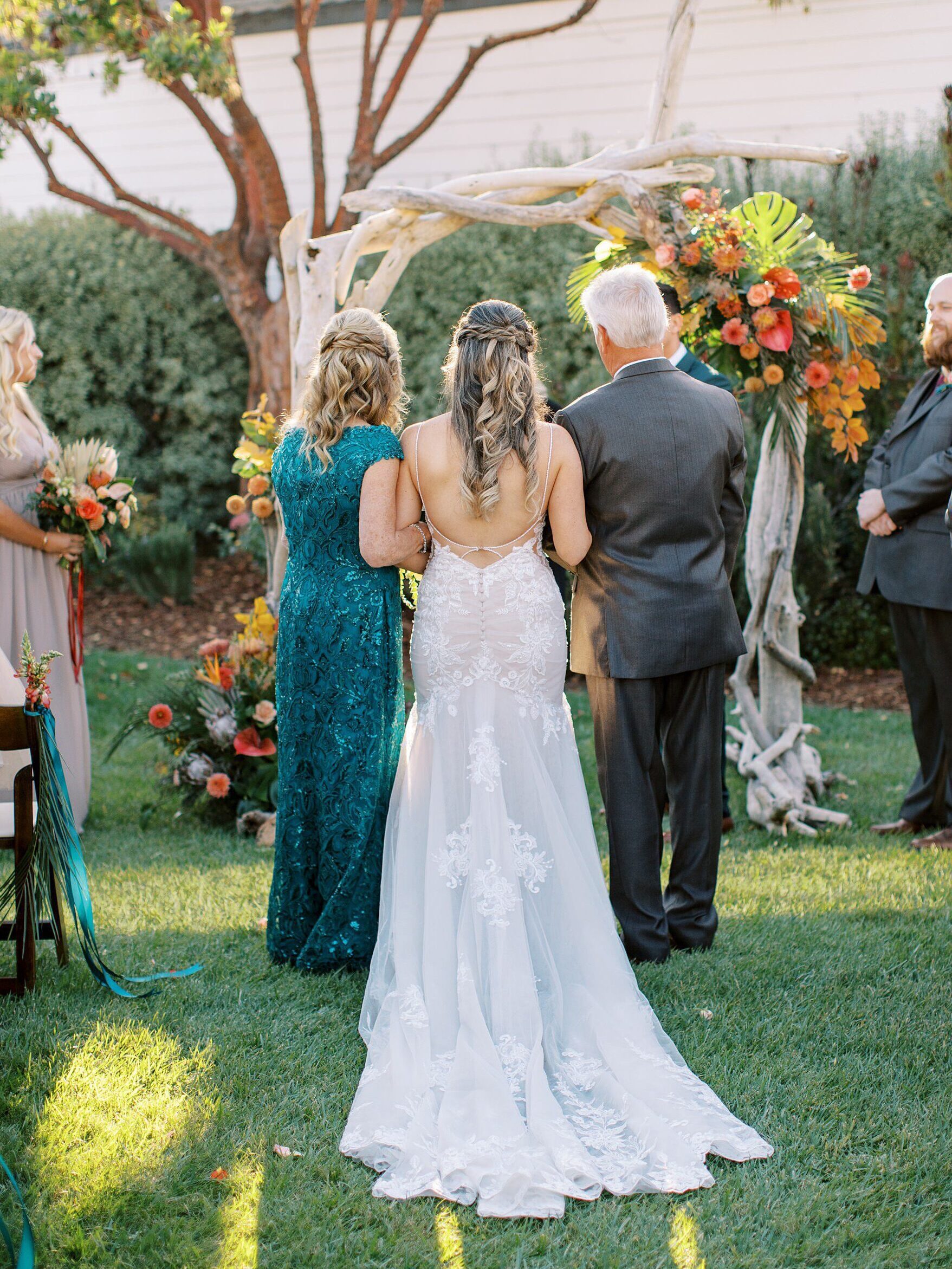 Mom and dad stand along daughter in wedding aisle by Cayucos Wedding Photographer on Film by Austyn Elizabeth Photography
