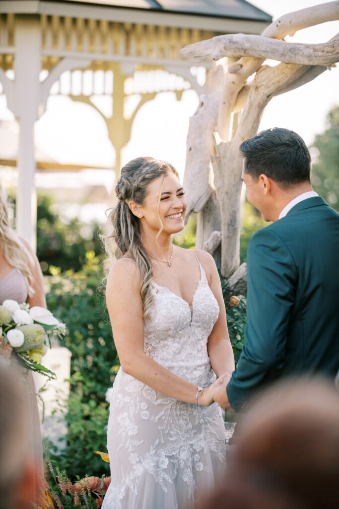 Bride smiling at groom during wedding ceremony by Cayucos Wedding Photographer on Film by Austyn Elizabeth Photography