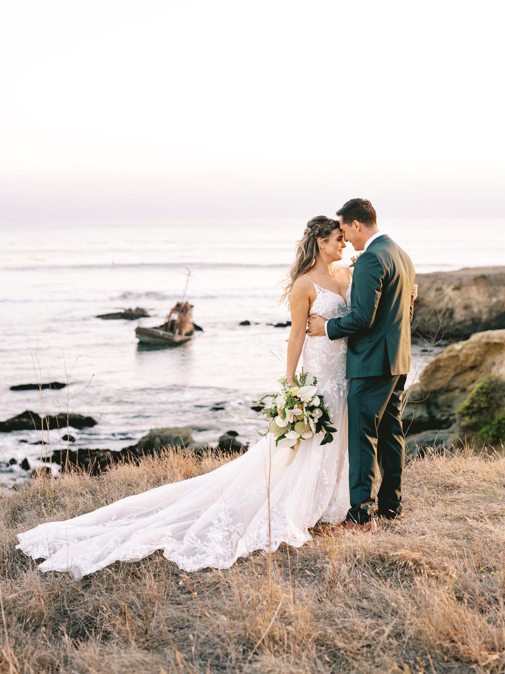 Couple hold eachother on the bluffs by Cayucos Wedding Photographer on Film by Austyn Elizabeth Photography