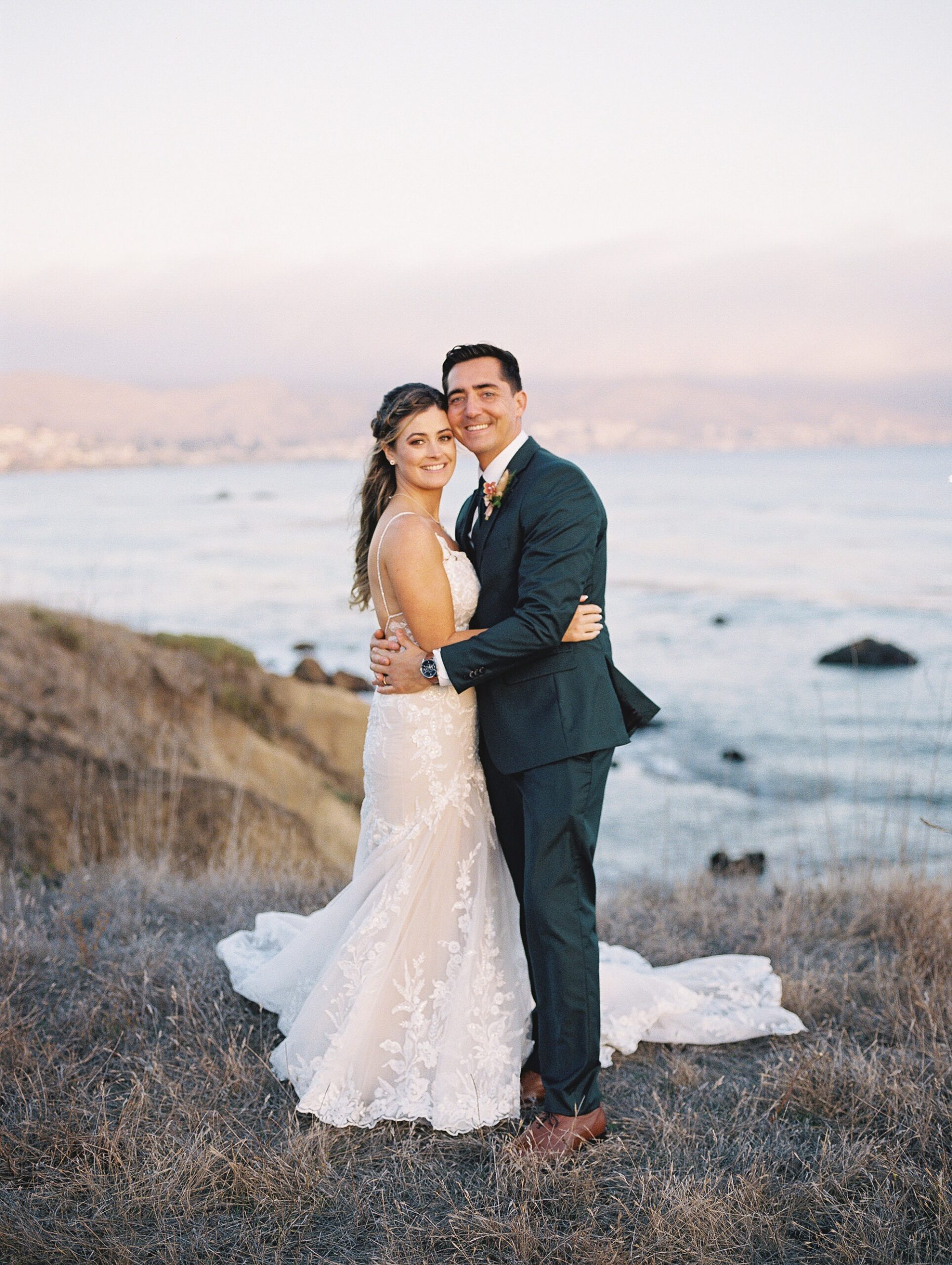 Couple stand with Morro Bay in the background by Cayucos Wedding Photographer on Film by Austyn Elizabeth Photography