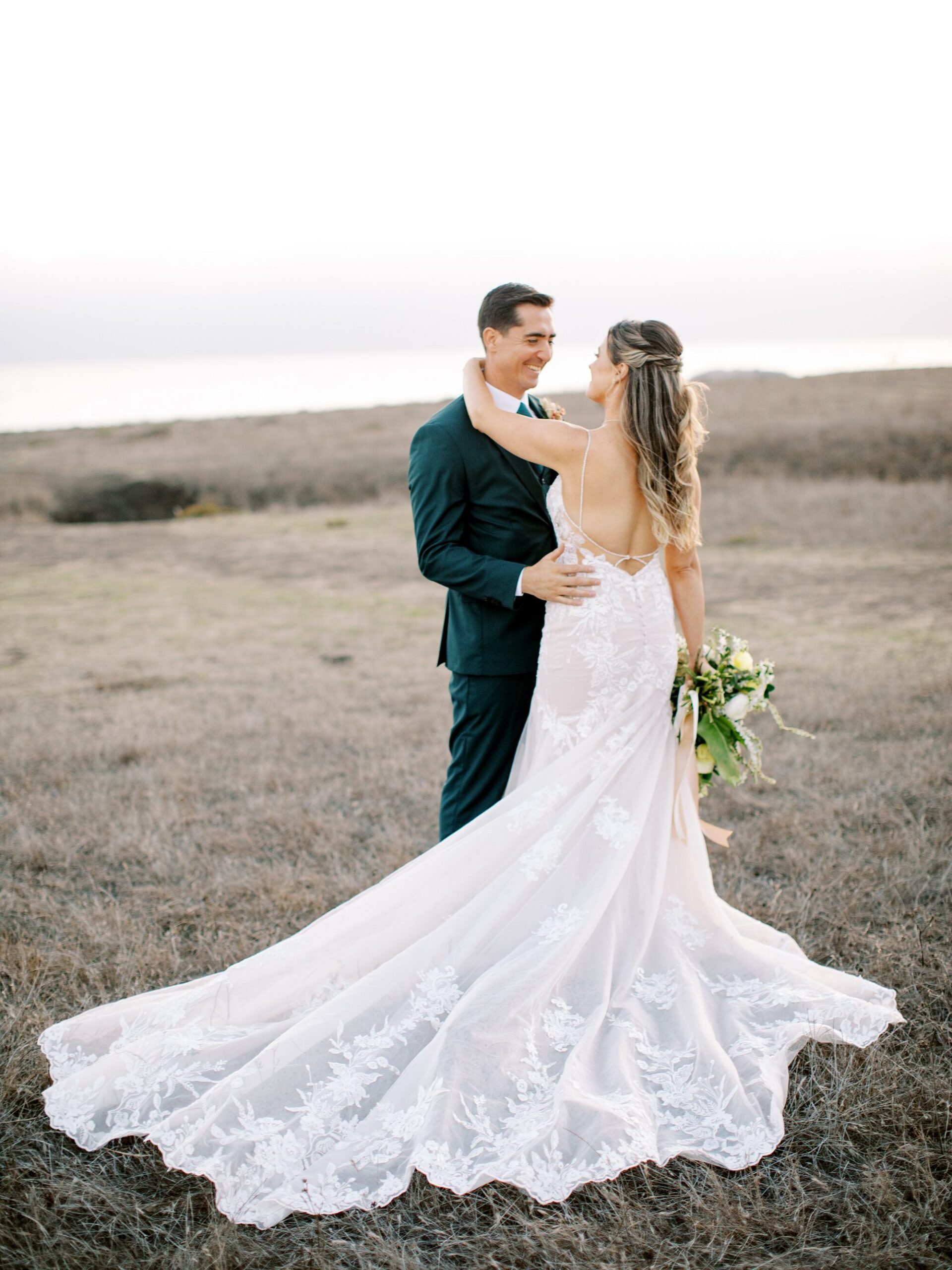 Bride's long train during sunset by Cayucos Wedding Photographer on Film by Austyn Elizabeth Photography