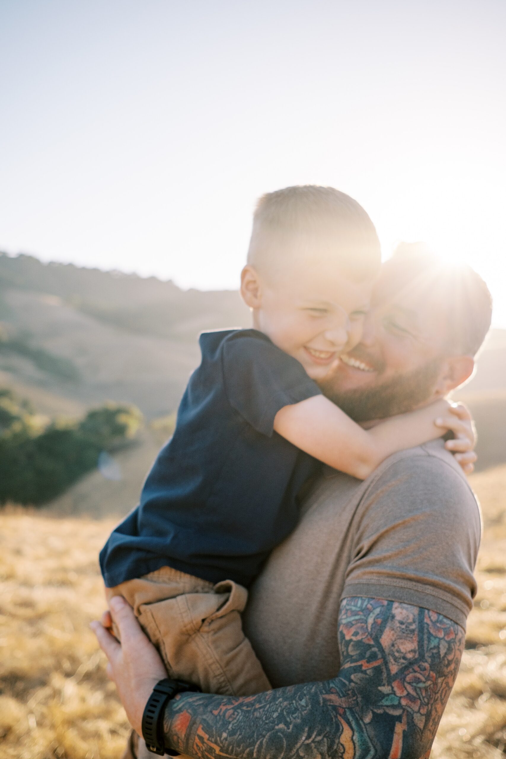 Dad and sun play and smile during San Luis Obispo family photos at Johnson Ranch Trail by Pismo Beach Family Photographer Austyn Elizabeth Photography