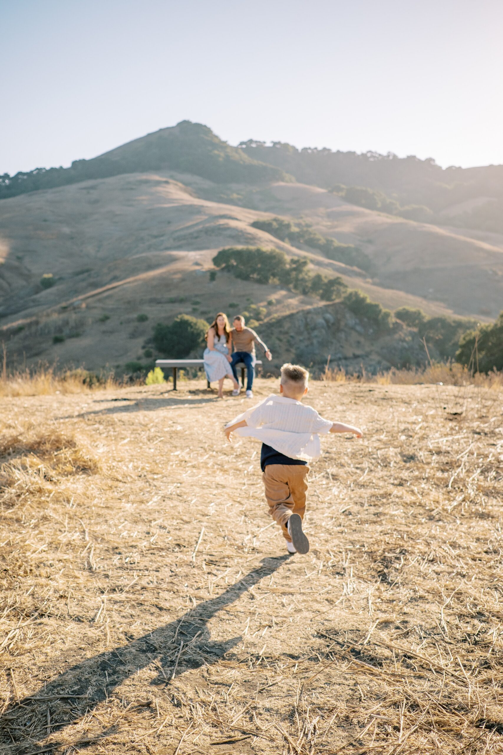 Little boy runs to parents at Johnson Ranch Trail by Pismo Beach Family Photographer Austyn Elizabeth Photography
