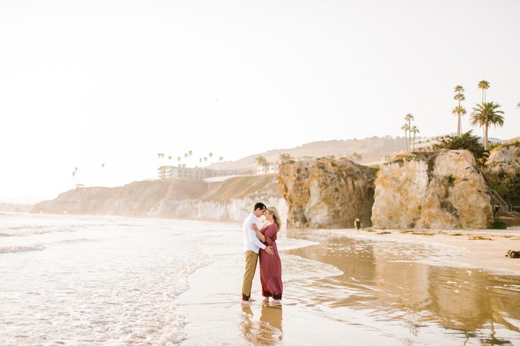 Couple rest forehead to forehead at Pismo beach by Pismo Beach Engagement Photographer Austyn Elizabeth Photography