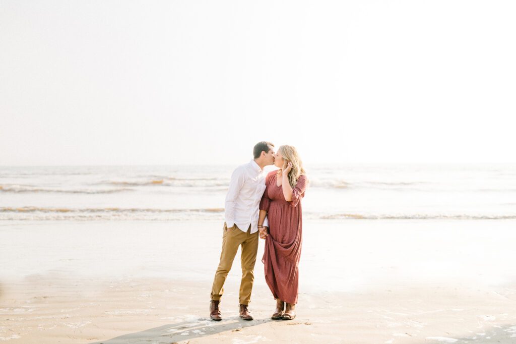 Couple kisses with ocean in the background by Pismo Beach Engagement Photographer Austyn Elizabeth Photography
