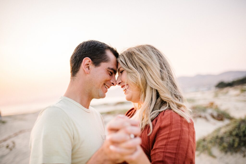 Couple slow dance during sunset by Pismo Beach Engagement Photographer Austyn Elizabeth Photography