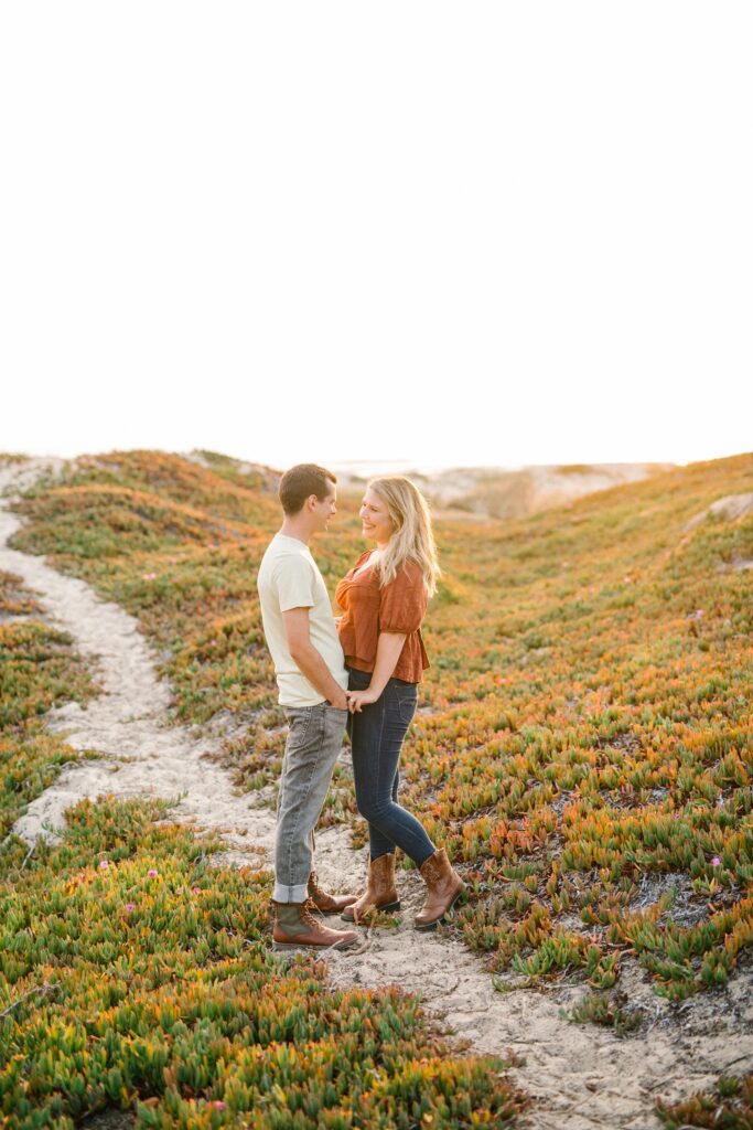 Holding hands in the dunes by Pismo Beach Engagement Photographer Austyn Elizabeth Photography