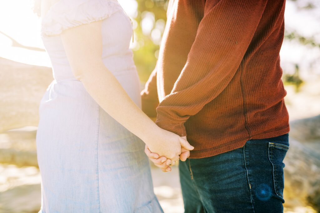 Close up of couple holding hands at pismo beach dunes for their Pismo Beach Anniversary by Pismo Beach Anniversary Photographer Austyn Elizabeth Photography