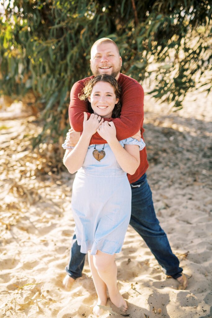 Tall guy and short girl pose at pismo beach dunes for their Pismo Beach Anniversary by Pismo Beach Anniversary Photographer Austyn Elizabeth Photography