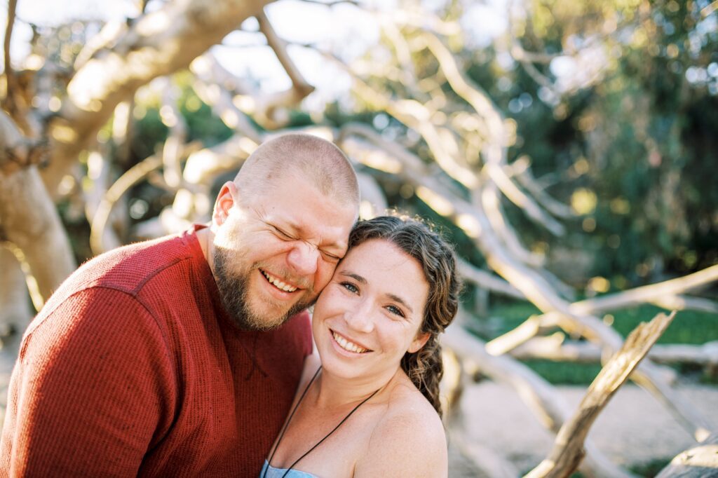 Groom laughs with bride smiling at the camera at pismo beach dunes for their Pismo Beach Anniversary by Pismo Beach Anniversary Photographer Austyn Elizabeth Photography