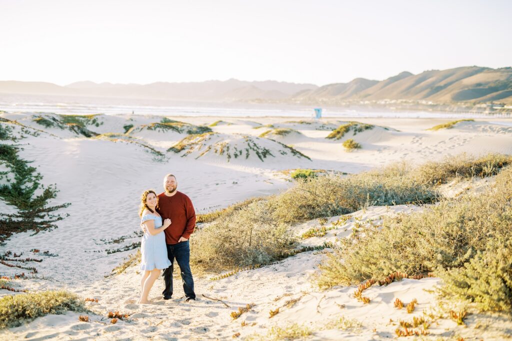 Woman in light blue dress and guy in deep read sweater at pismo beach dunes for their Pismo Beach Anniversary by Pismo Beach Anniversary Photographer Austyn Elizabeth Photography