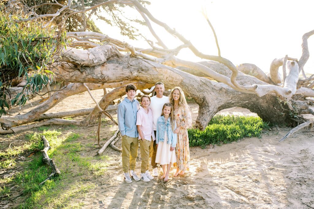 Family with fallen eucalyptus tree at Pismo Beach dunes by Pismo Beach Family Photographer Austyn Elizabeth Photography