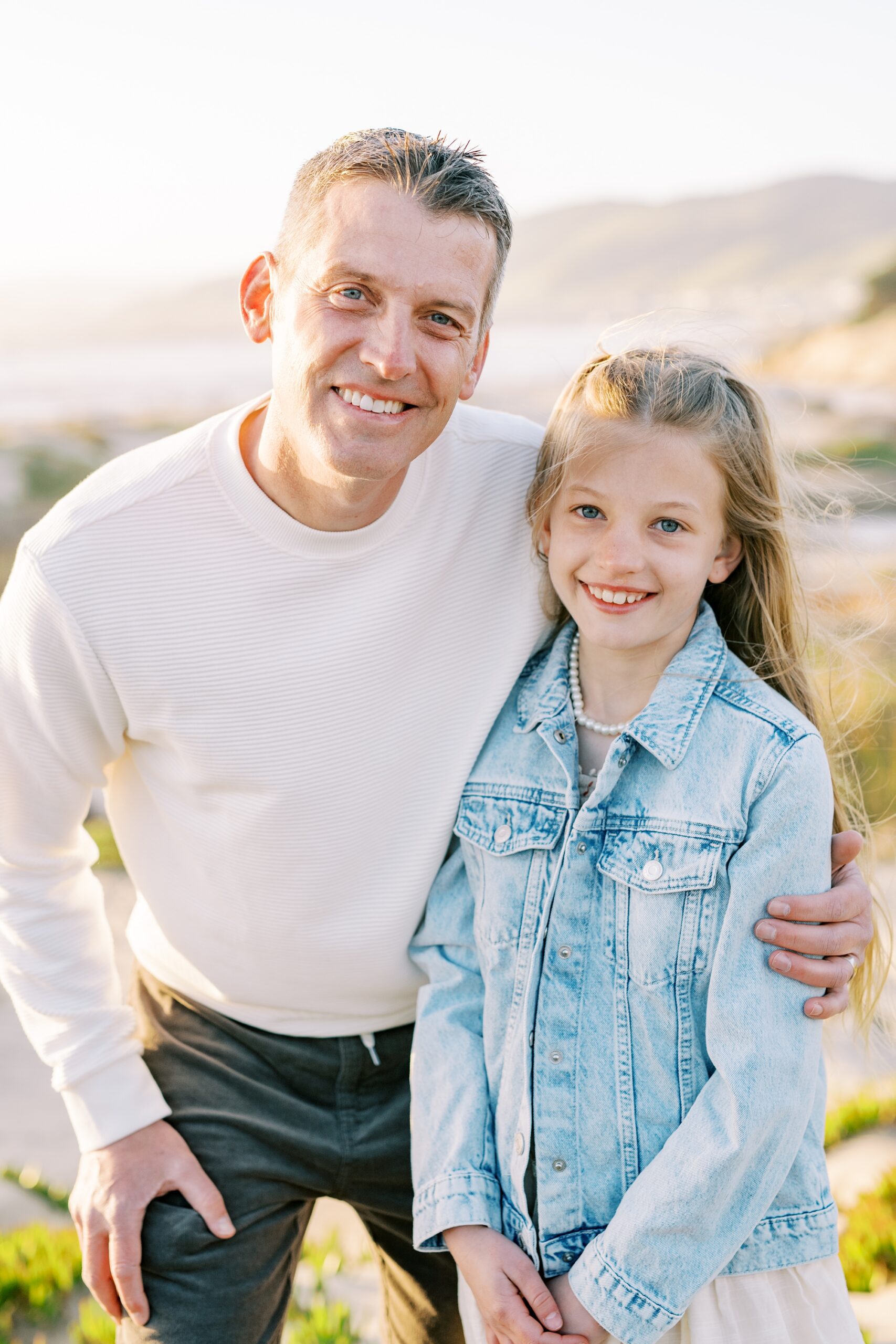 Dad and daughter embrace and smile at the camera by Pismo Beach Family Photographer Austyn Elizabeth Photography
