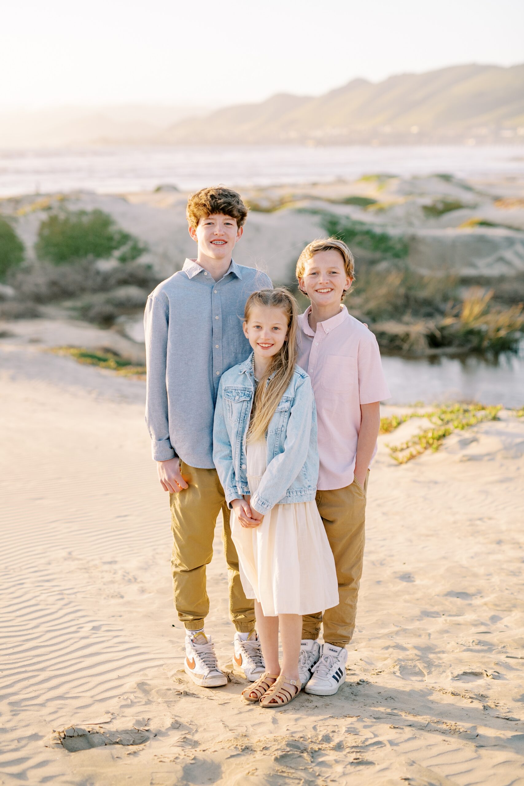 Kids stand with pismo beach in the background by Pismo Beach Family Photographer Austyn Elizabeth Photography