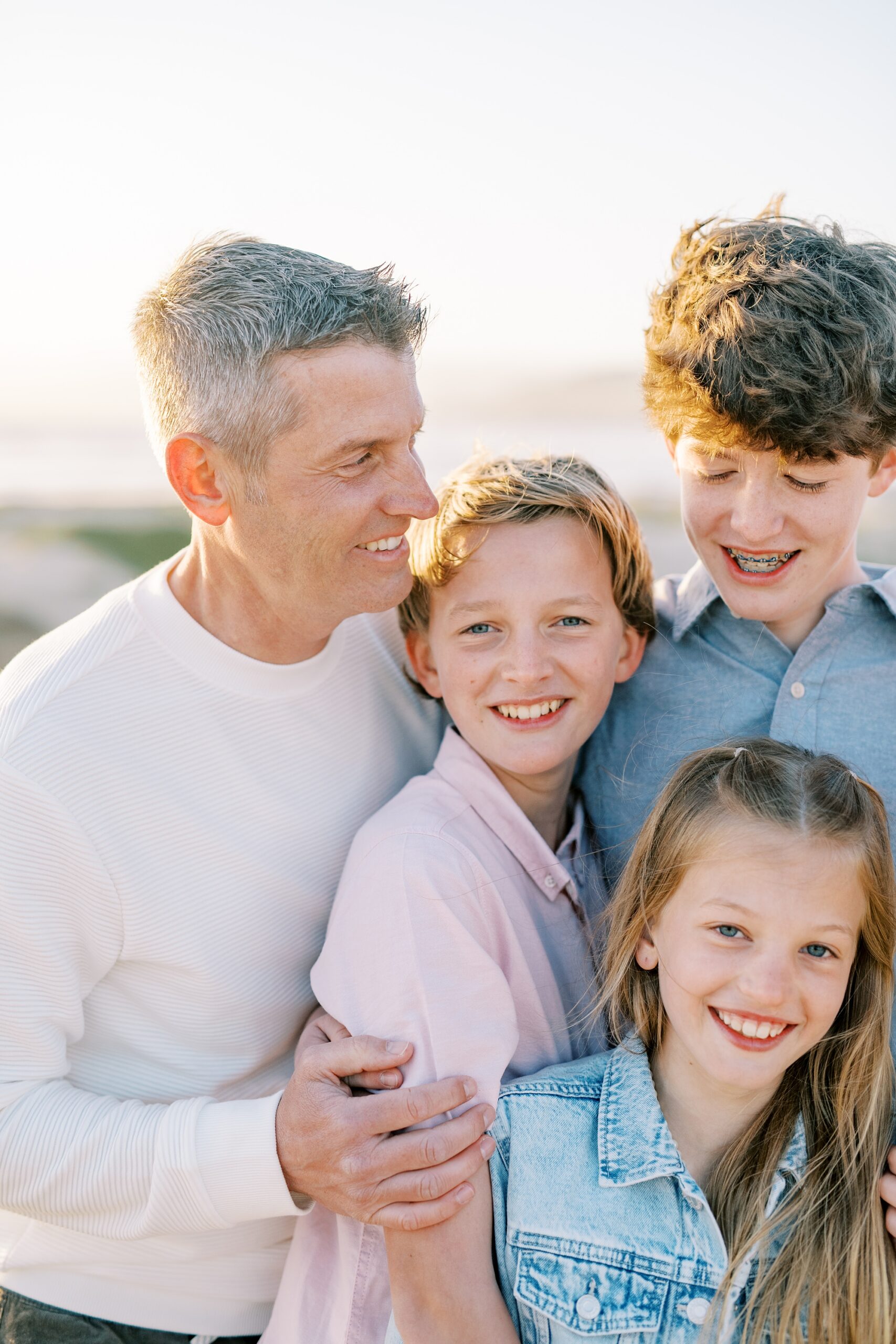 Family embraces together by Pismo Beach Family Photographer Austyn Elizabeth Photography
