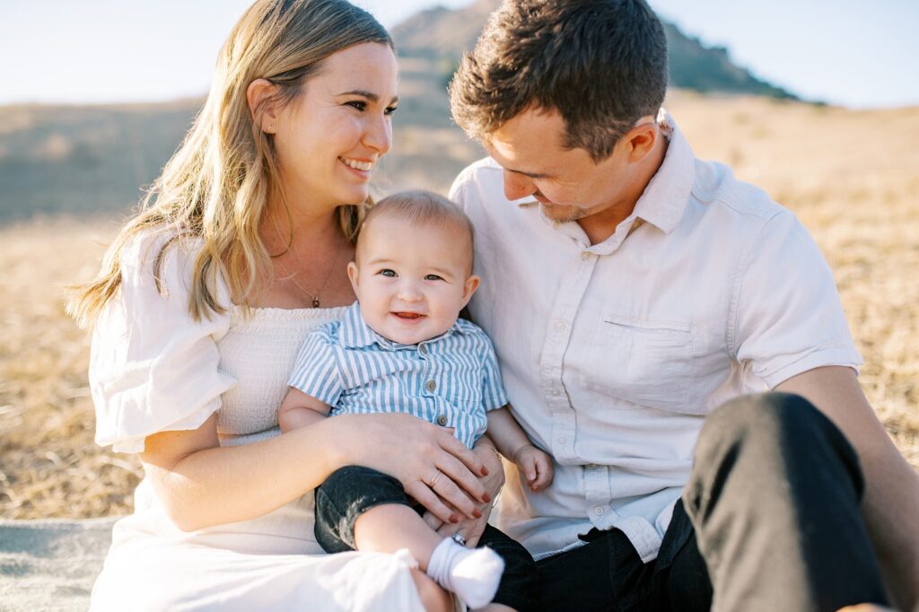Mom holding baby and everyone smiling at Bishop Peak family photos by San Luis Obispo Family Photographer Austyn Elizabeth Photography 