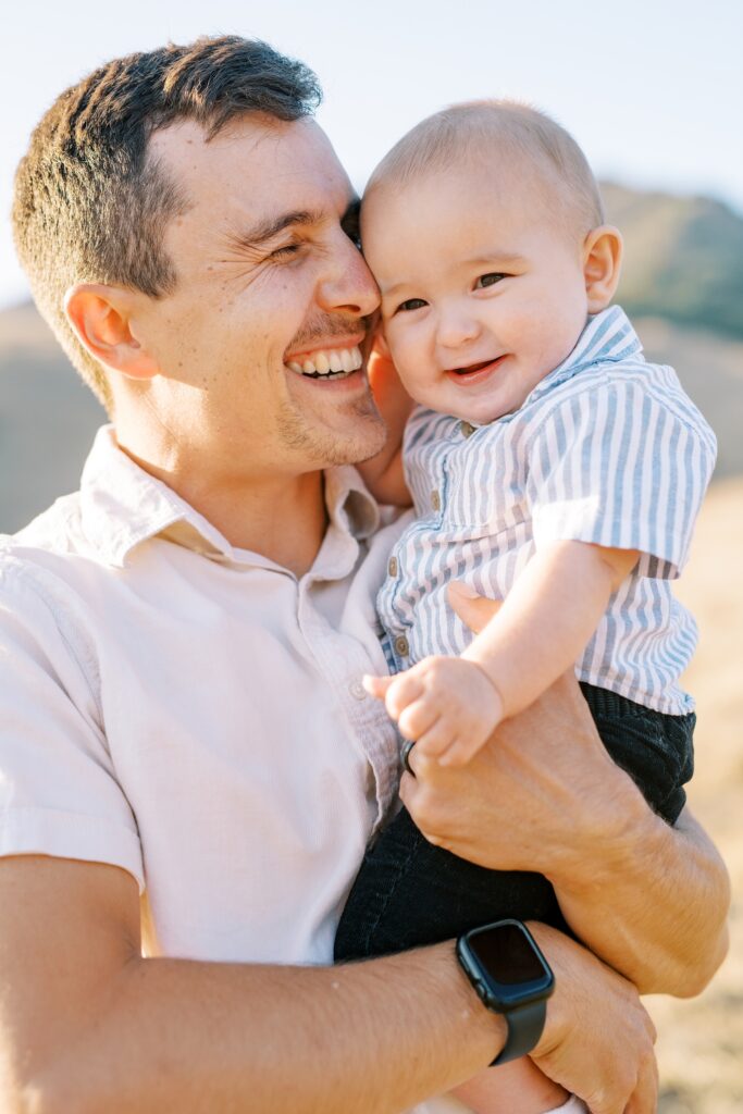 Dad and baby boy cuddling at Bishop Peak family photos by San Luis Obispo Family Photographer Austyn Elizabeth Photography 