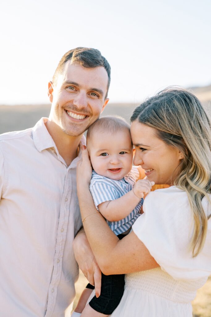 Sweet family cuddle together during their golden hour Bishop Peak family photos by San Luis Obispo Family Photographer Austyn Elizabeth Photography 
